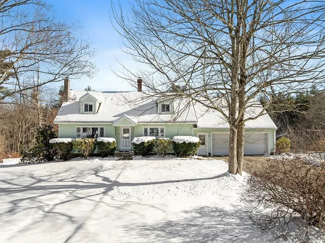 a view of house with a yard covered in snow