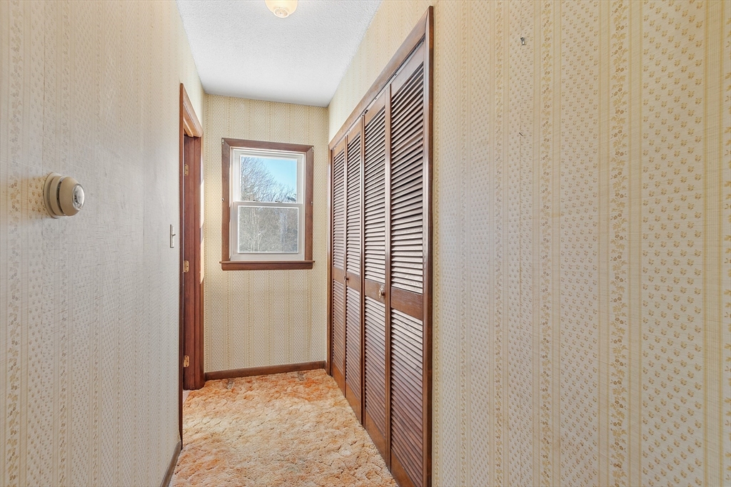 318 Lovewell Street Gardner, MA 01440 - Photo 24 of 42 a view of a hallway with wooden floor and a bathroom