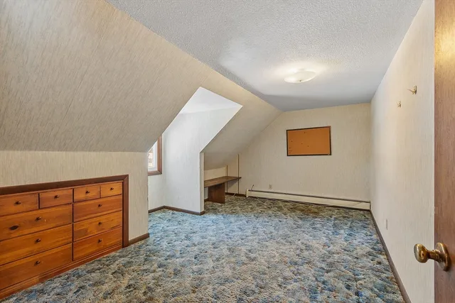 an empty room with windows and cabinet