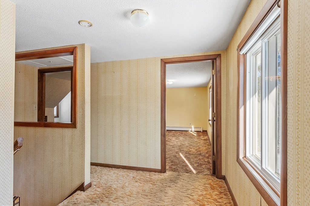 318 Lovewell Street Gardner, MA 01440 - Photo 33 of 42 a view of a small space with wooden floor and a window