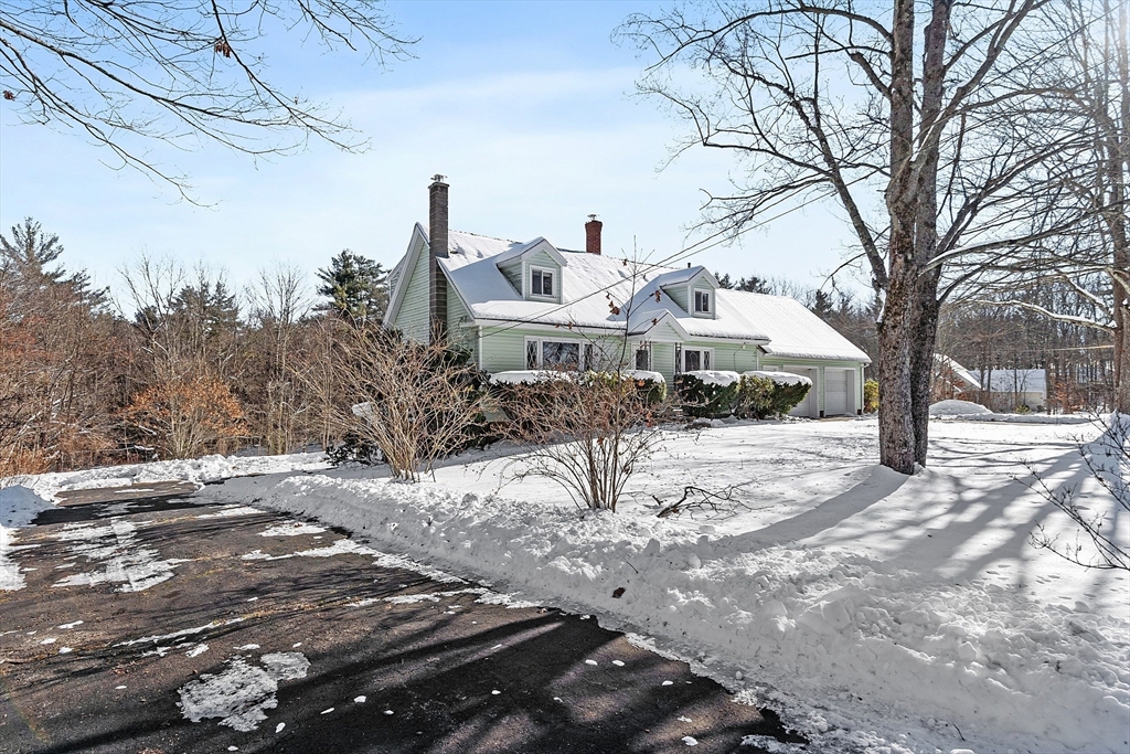 318 Lovewell Street Gardner, MA 01440 - Photo 37 of 42 a front view of a house with a yard covered in snow