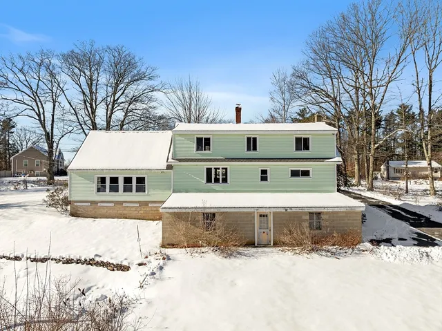 a view of a house with snow on the background