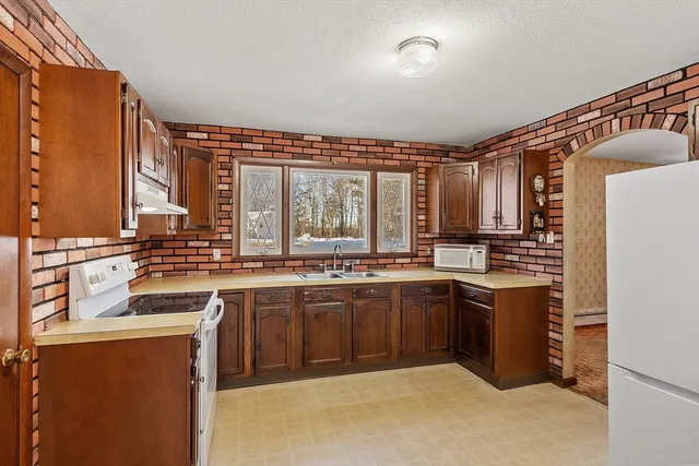 a kitchen with stainless steel appliances granite countertop a sink and cabinets