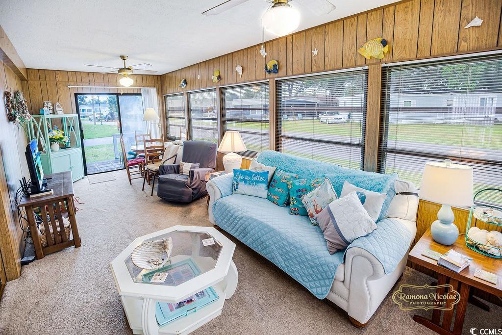 298 Flamingo Surfside Beach, SC 29575 - Photo 26 of 31 Living room featuring carpet floors, wood walls, and a ceiling fan