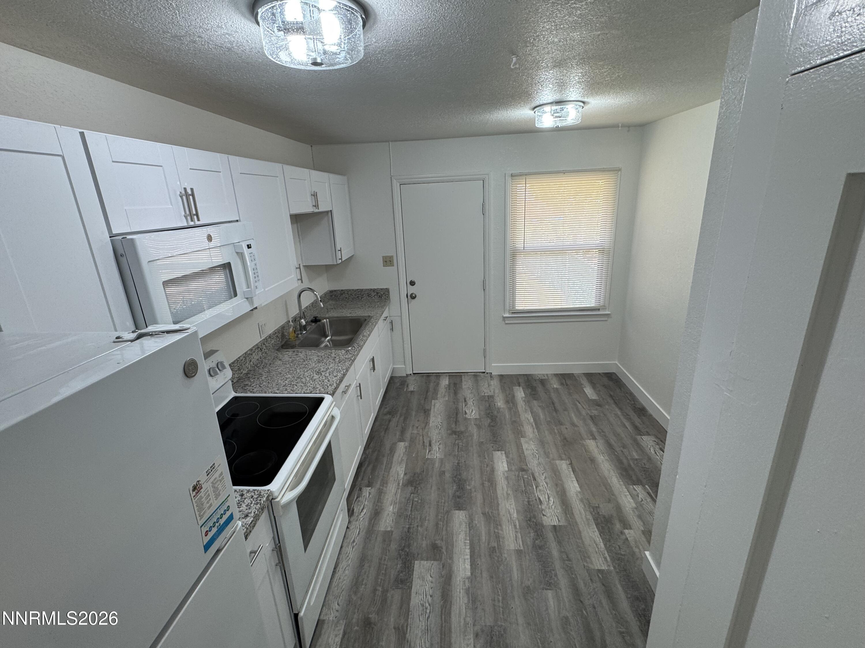70 Arden Circle Reno, NV 89503 - Photo 4 of 15 a workspace with wooden floor and windows
