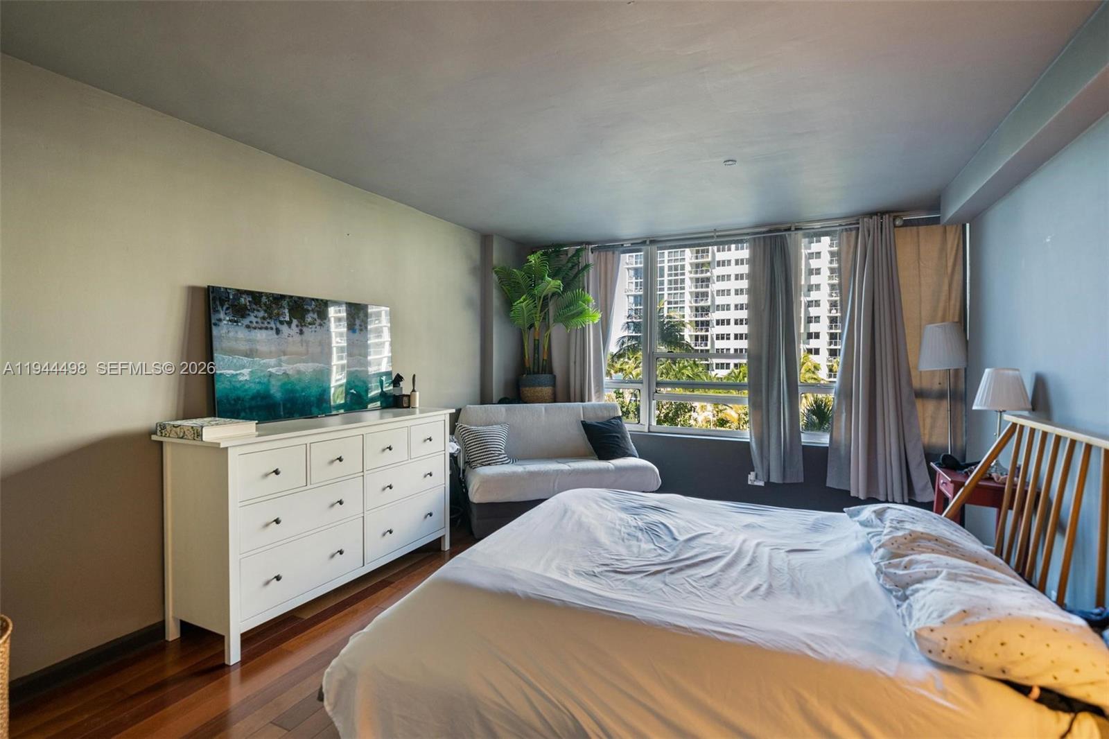 1500 Bay Road, Unit 458S Miami Beach, FL 33139 - Photo 11 of 41 a bedroom with furniture and a large window