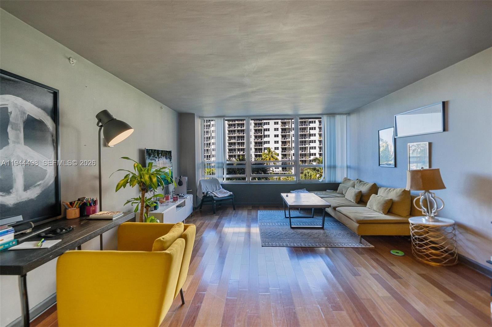1500 Bay Road, Unit 458S Miami Beach, FL 33139 - Photo 2 of 41 a living room with furniture and a flat screen tv