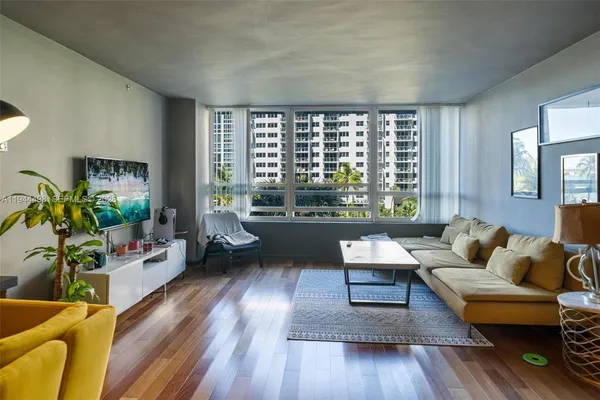 a living room with furniture and a large window