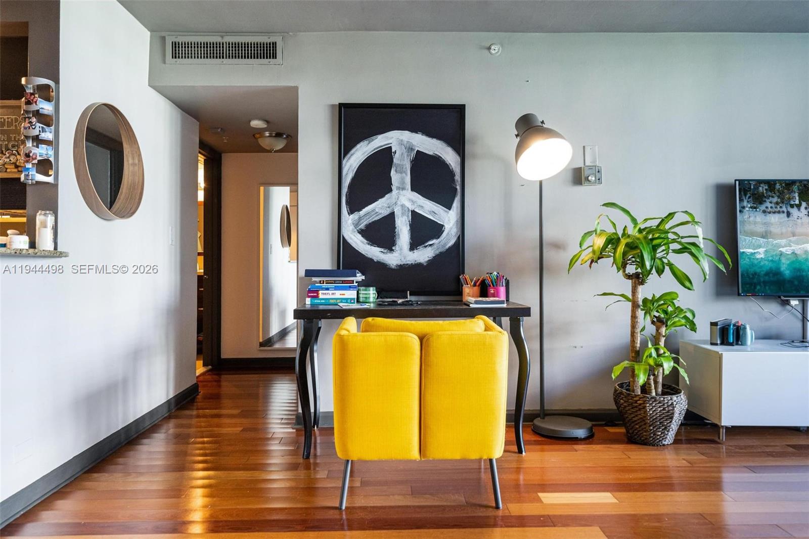 1500 Bay Road, Unit 458S Miami Beach, FL 33139 - Photo 5 of 41 a living room with furniture and a mirror