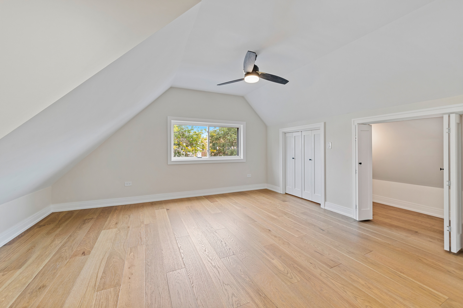 1622 North Spaulding Avenue Chicago, IL 60647 - Photo 26 of 50 an empty room with wooden floor chandelier fan and windows