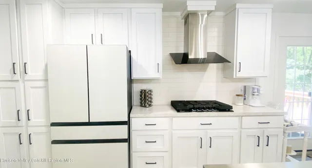 a kitchen with stainless steel appliances white cabinets and a counter