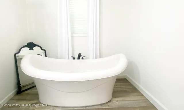 a white bath tub sitting in a bathroom