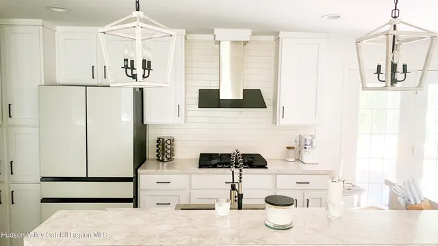 a kitchen with kitchen island a sink a stove and refrigerator