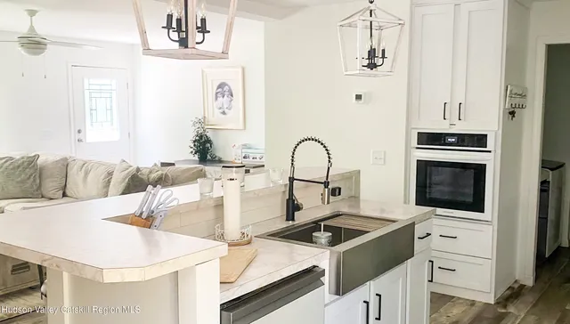 a kitchen with a stove a sink and a refrigerator
