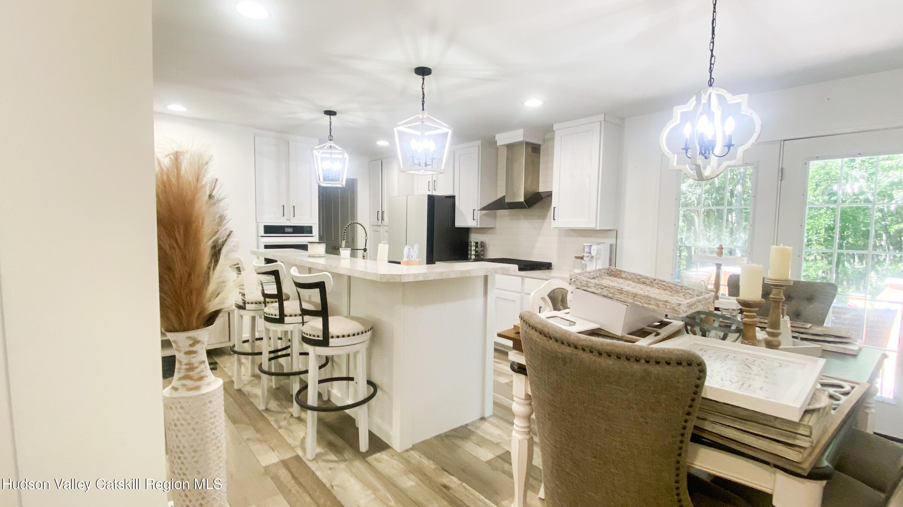 241 Upper North Road Highland, NY 12528 - Photo 10 of 25 a living room with kitchen island furniture and a chandelier