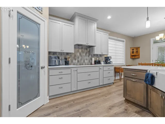 a kitchen with a refrigerator and a sink