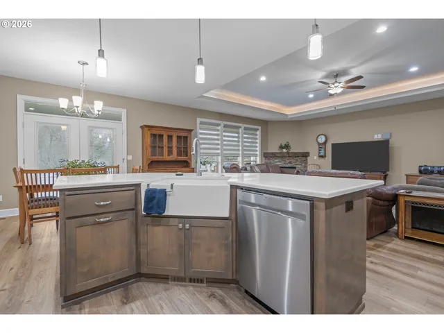 a kitchen with kitchen island a sink stainless steel appliances and cabinets