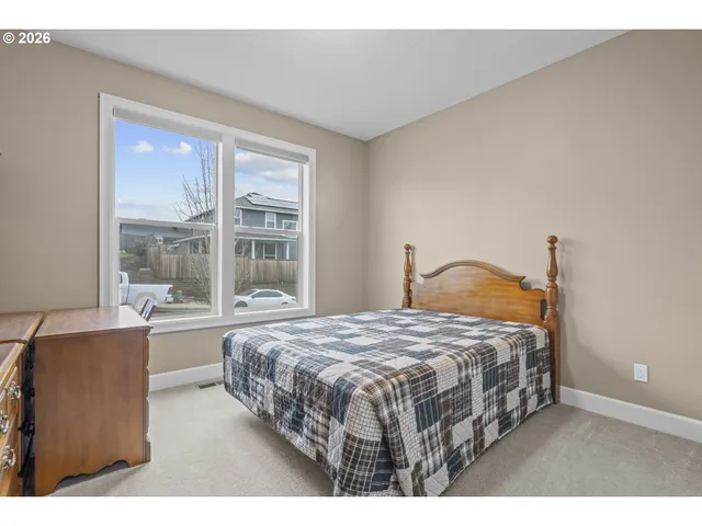 a bedroom with a bed and window