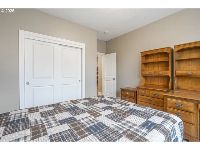 a bedroom with a bed and cabinets