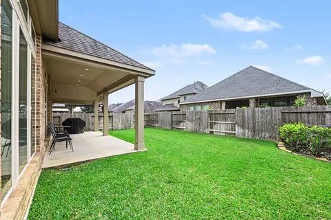 a view of a patio with a table and chairs under an umbrella