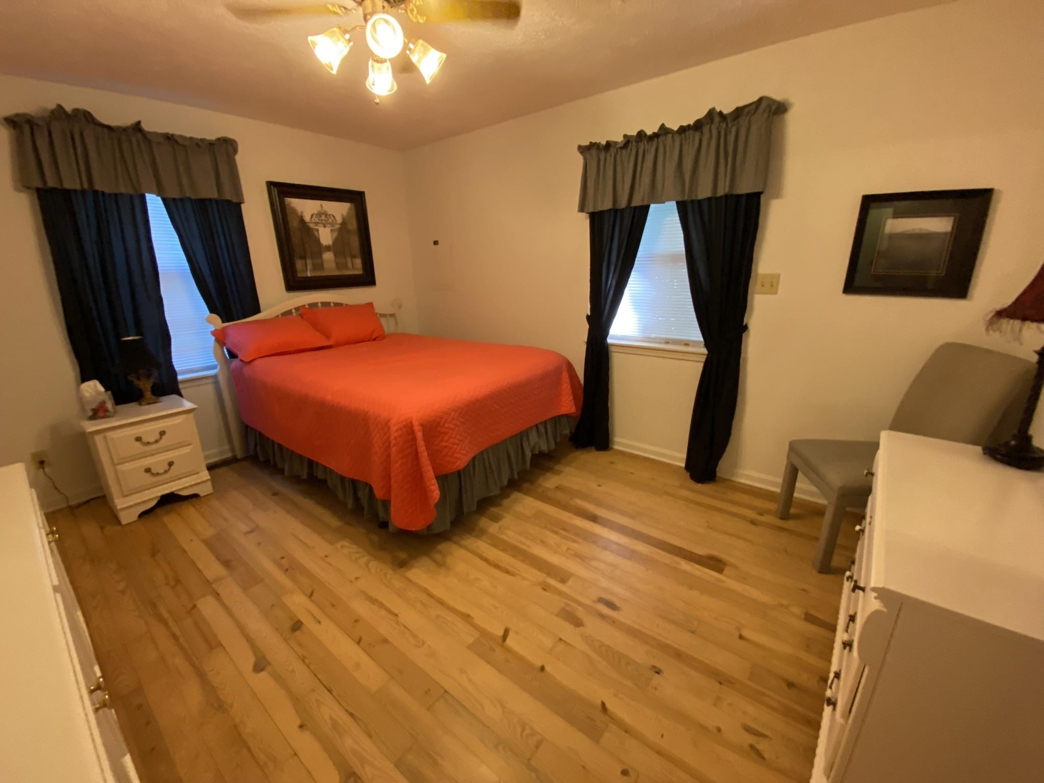 70 Mockingbird Road Henderson, TN 38340 - Photo 14 of 47 a bedroom with a bed a flat screen tv and painting on the wall