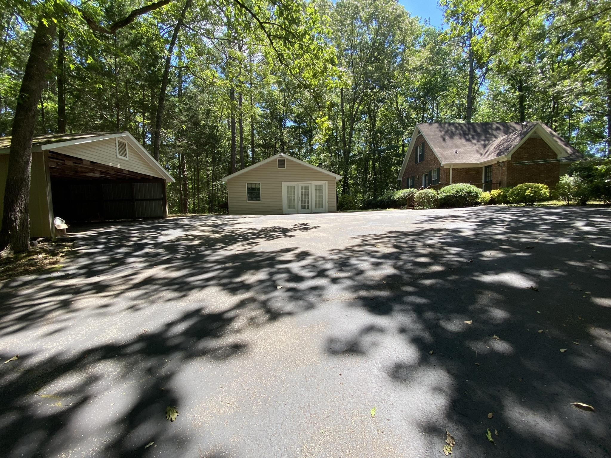 70 Mockingbird Road Henderson, TN 38340 - Photo 2 of 47 a front view of a house with a yard and garage