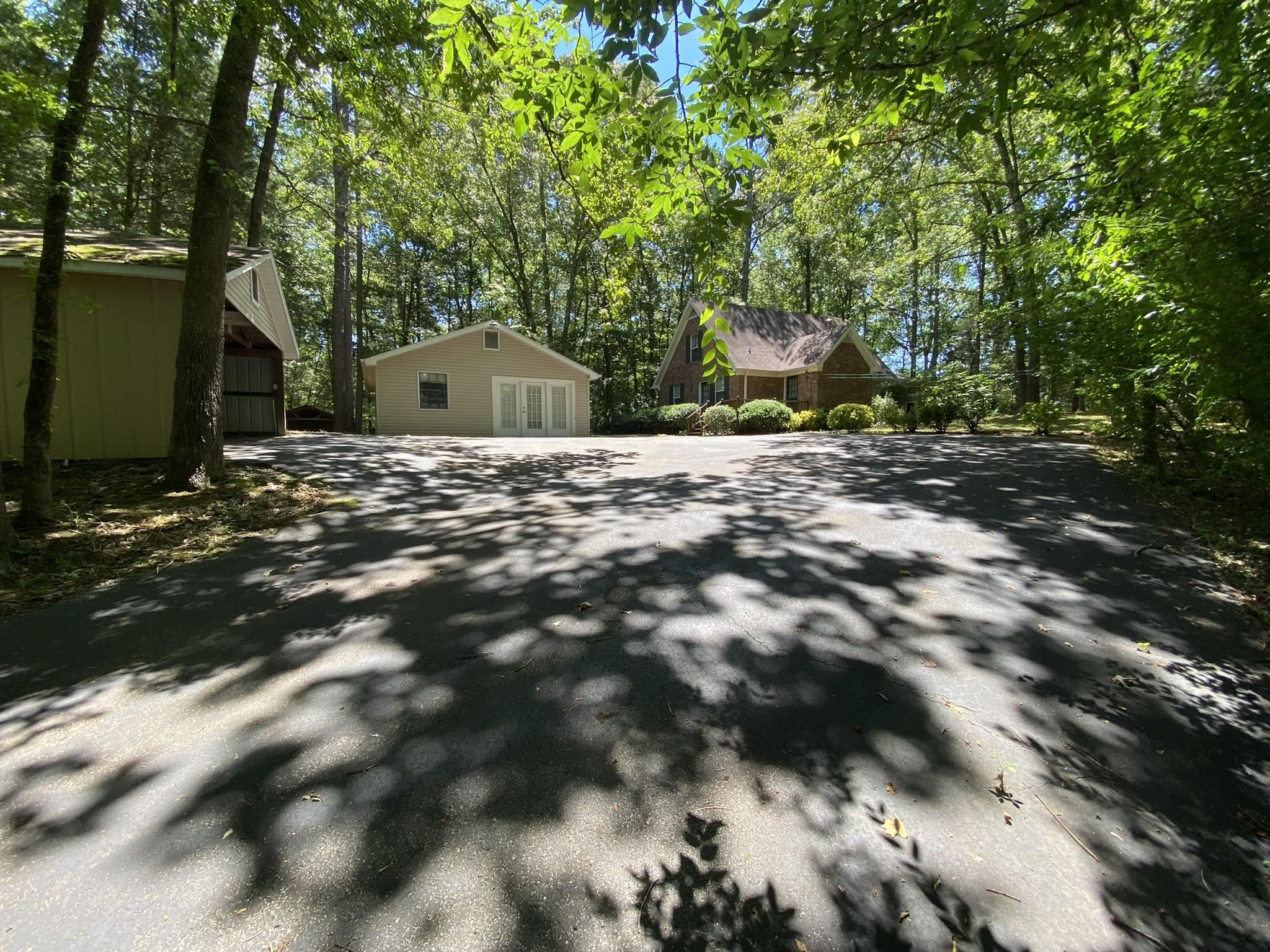 70 Mockingbird Road Henderson, TN 38340 - Photo 47 of 47 a backyard of a house with large trees and plants