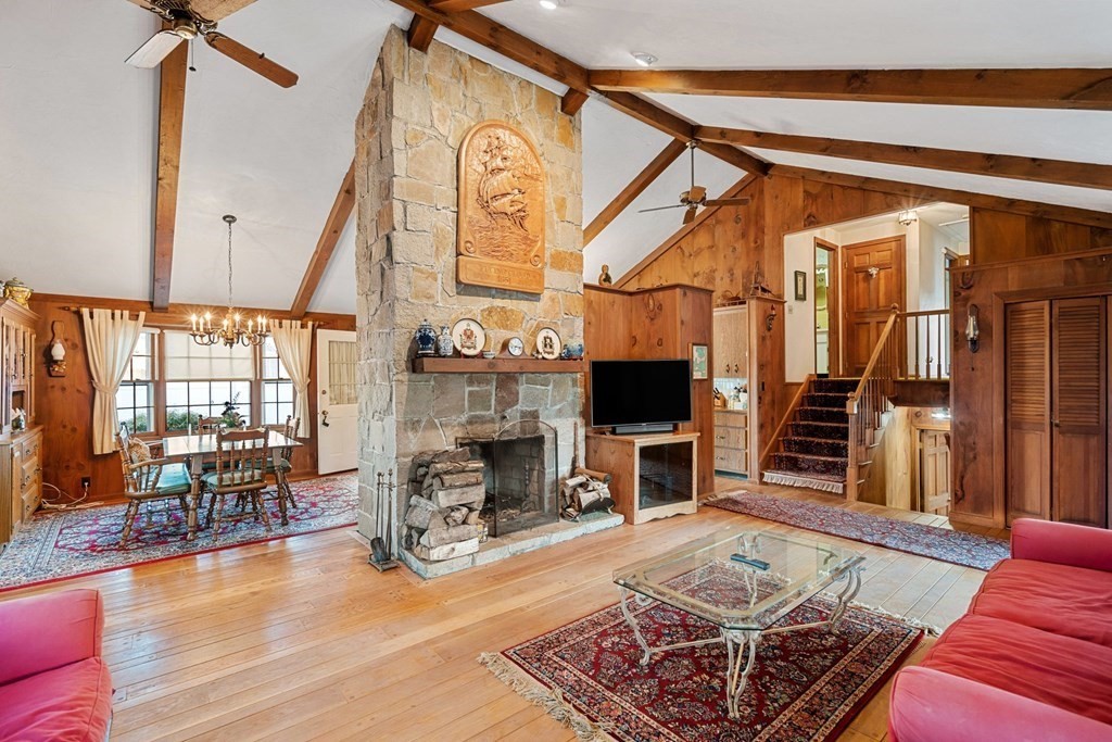 60 Beaten Road Dennis, MA 02639 - Photo 2 of 26 a living room with furniture a fireplace and a flat screen tv