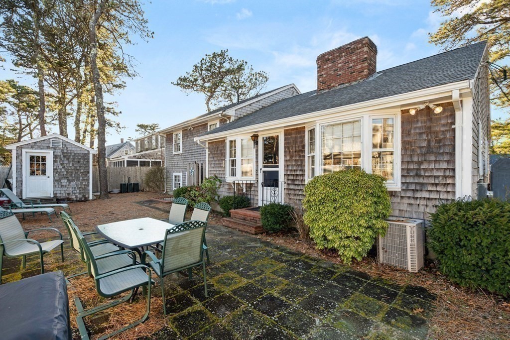 60 Beaten Road Dennis, MA 02639 - Photo 22 of 26 a view of a patio with table and chairs and potted plants