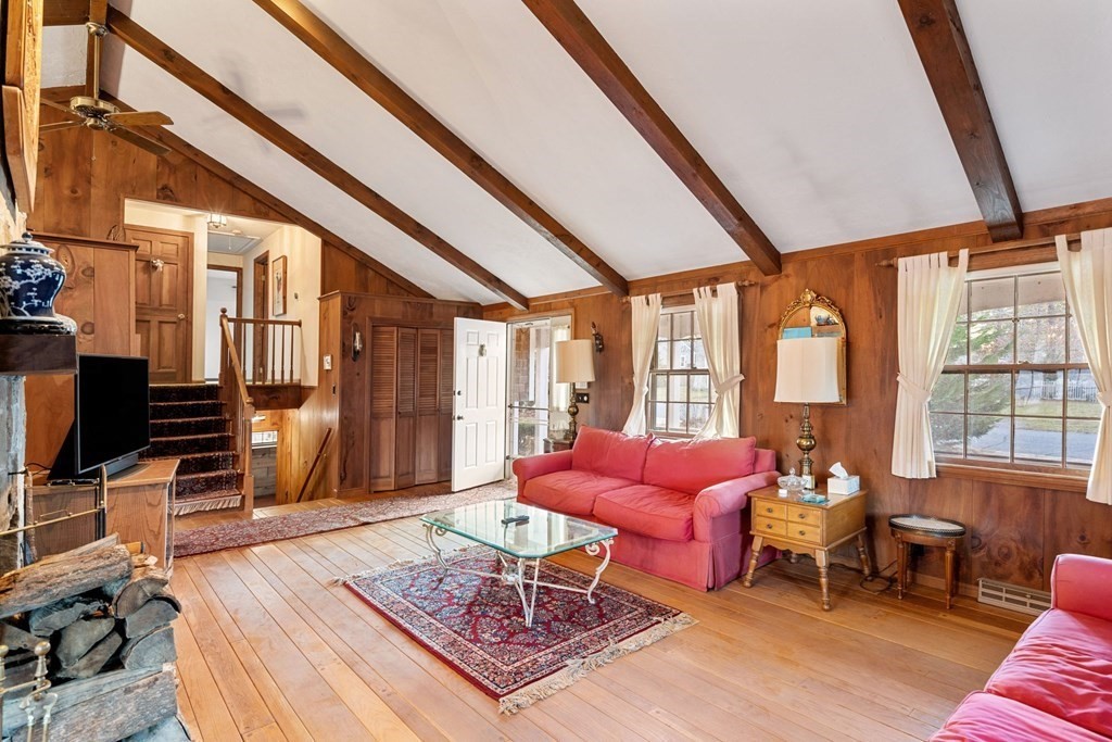 60 Beaten Road Dennis, MA 02639 - Photo 4 of 26 a living room with furniture a rug and a floor to ceiling window