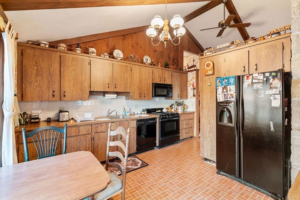 60 Beaten Road Dennis, MA 02639 - Photo 7 of 26 a kitchen with stainless steel appliances a stove a sink dishwasher a refrigerator with a dining table and chairs