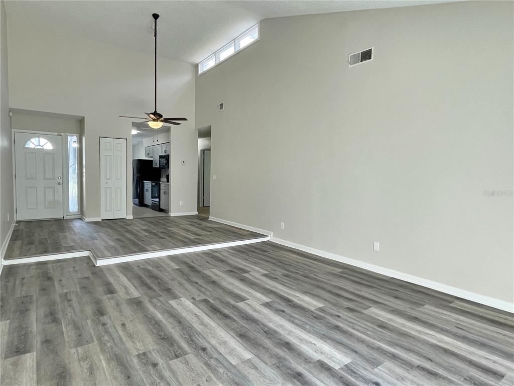 702 St Matthew Circle Altamonte Springs, FL 32714 - Photo 11 of 27 a view of an empty room with a chandelier