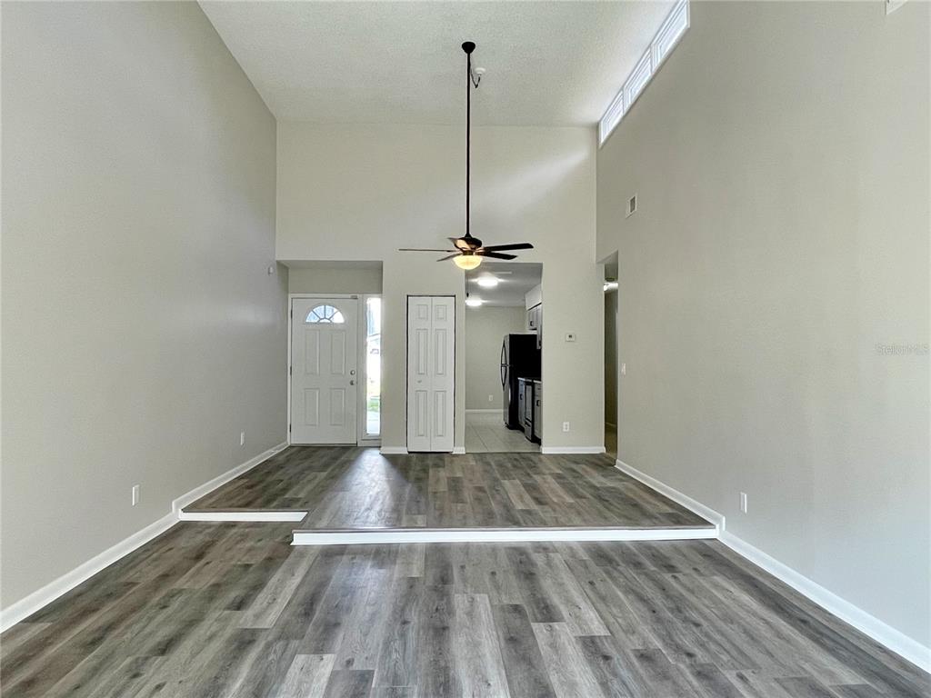702 St Matthew Circle Altamonte Springs, FL 32714 - Photo 12 of 27 a view of empty room with wooden floor and ceiling fan