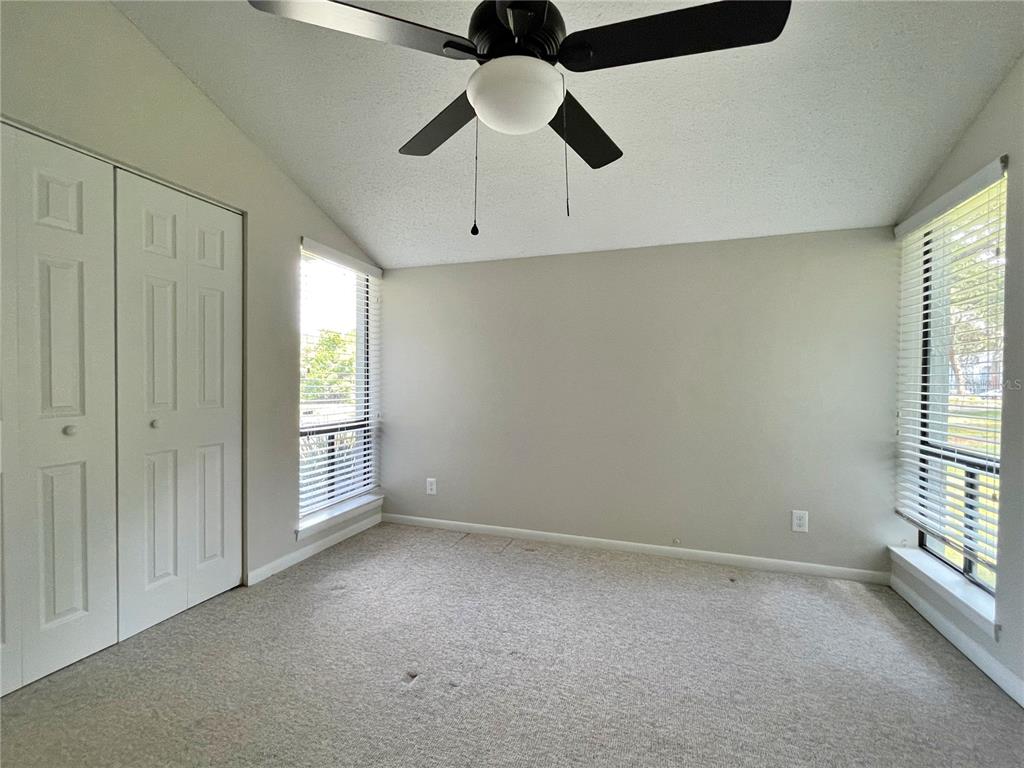 702 St Matthew Circle Altamonte Springs, FL 32714 - Photo 18 of 27 en empty room with windows and ceiling fan