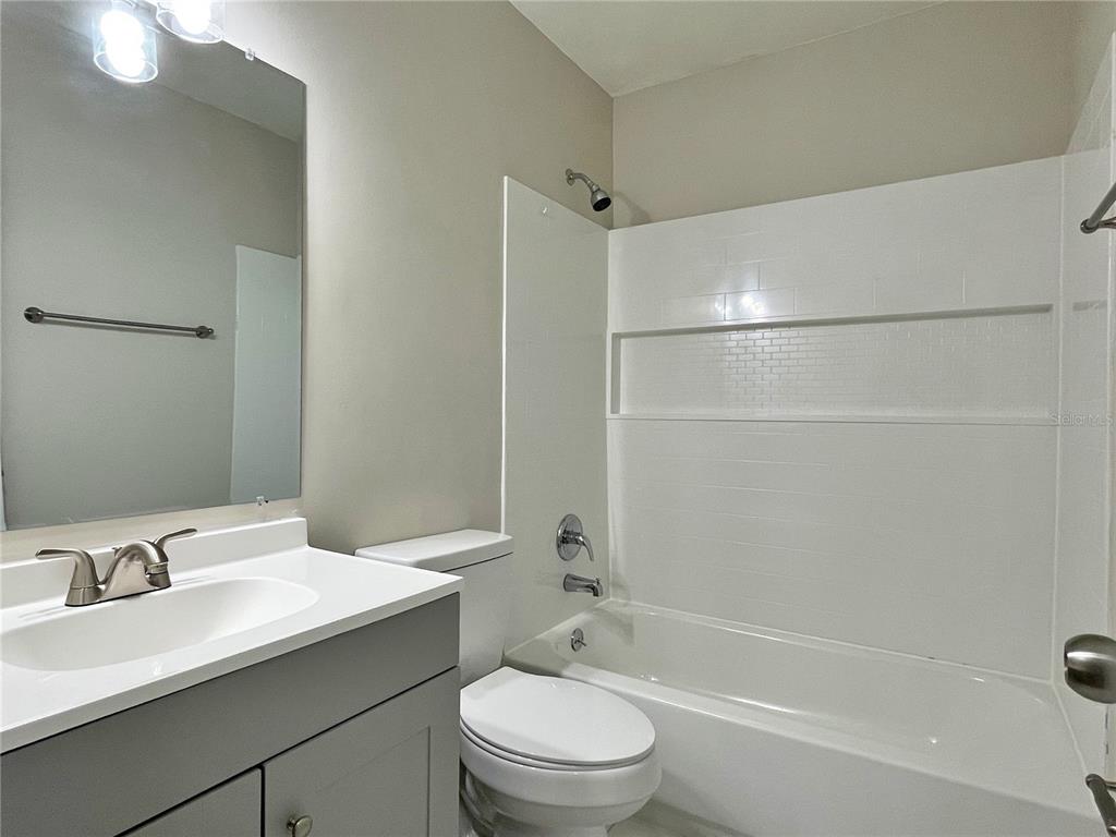 702 St Matthew Circle Altamonte Springs, FL 32714 - Photo 19 of 27 a bathroom with a bathtub shower sink vanity mirror and toilet