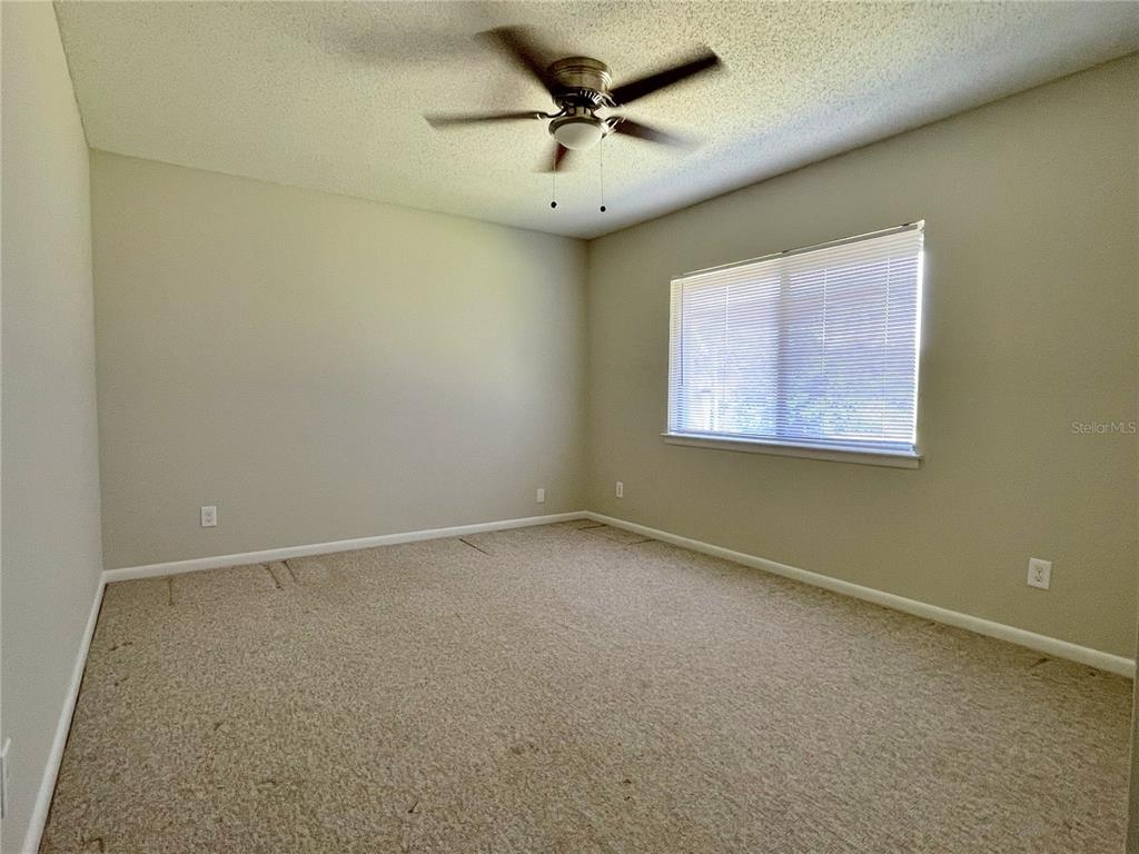 702 St Matthew Circle Altamonte Springs, FL 32714 - Photo 20 of 27 an empty room with a window and a fan