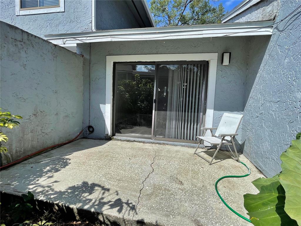 702 St Matthew Circle Altamonte Springs, FL 32714 - Photo 22 of 27 a backyard of a house with table and chairs