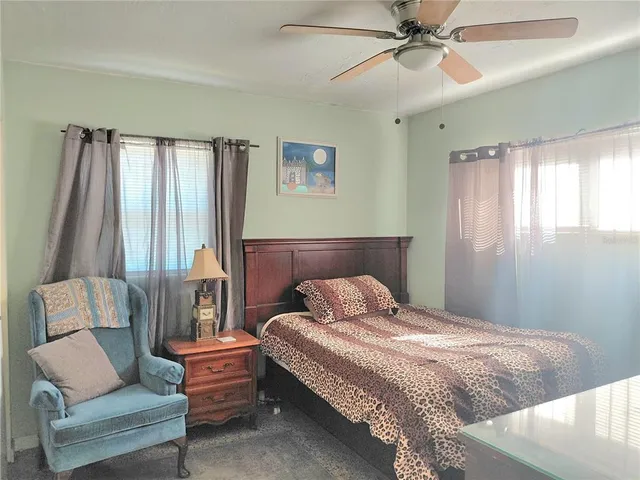 a bedroom with a bed and a couch