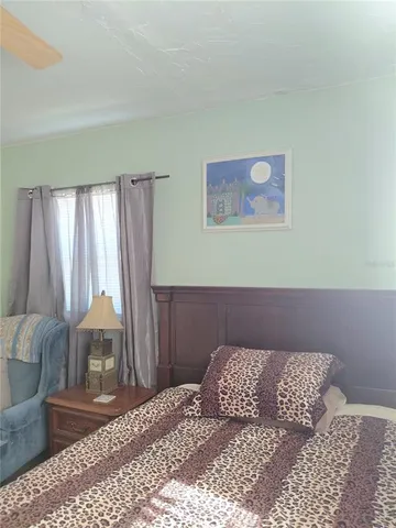 a bedroom with a bed and window