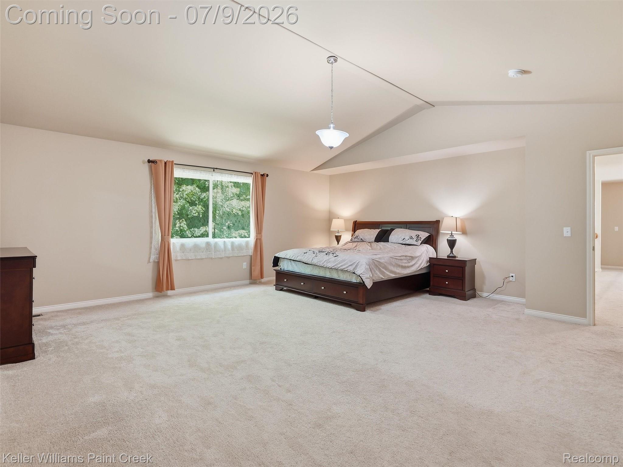846 Monterey Ln. Rochester, MI 48307 - Photo 28 of 52 Spacious room featuring vaulted ceilings, a large window, light-toned carpeting, and neutral wall paint