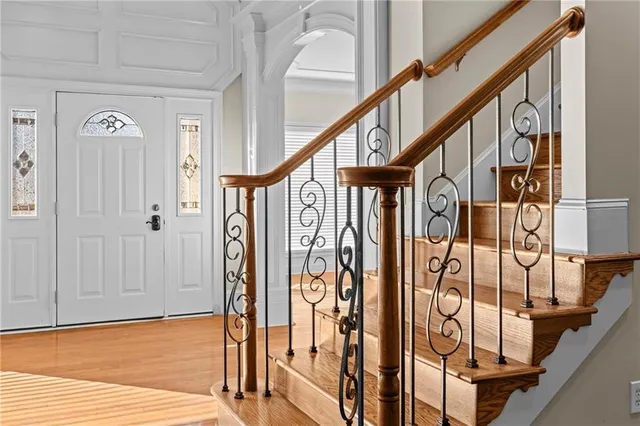 a view of an entryway with wooden floor and stairs