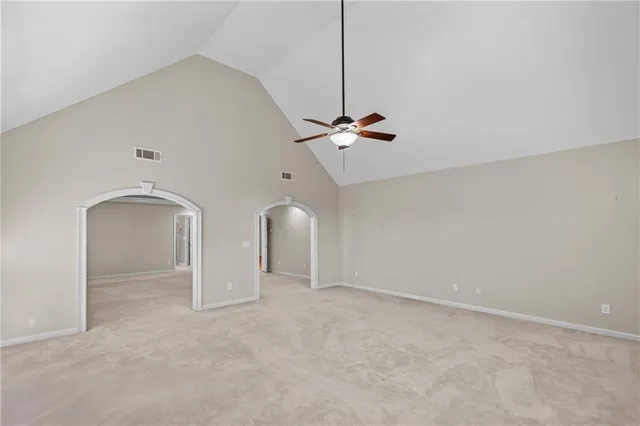 a spacious bathroom with a tub sink shower and mirror