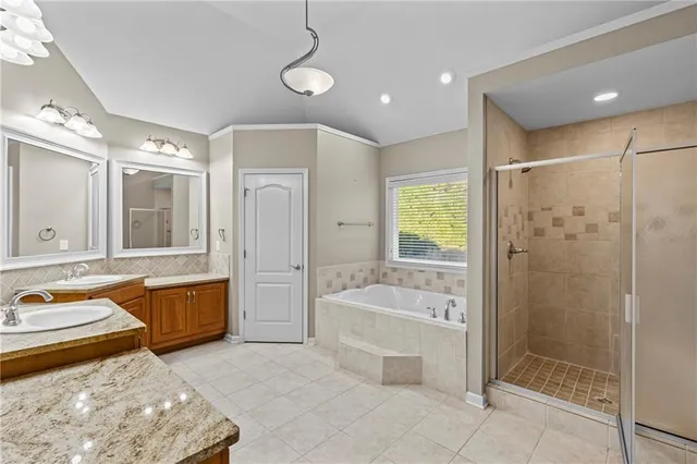 a large spacious bathroom with a granite countertop tub sink shower and mirror