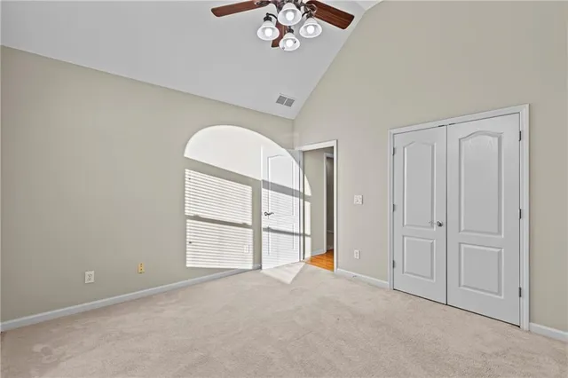 an empty room with windows and closet