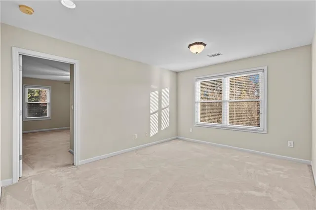 a bathroom with a granite countertop toilet a sink a mirror a shower and a bathtub