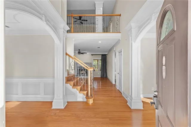 a view of entryway and hall with wooden floor