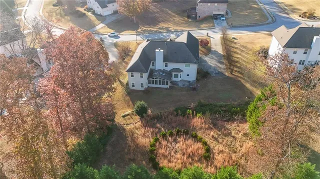 an aerial view of a house with a yard