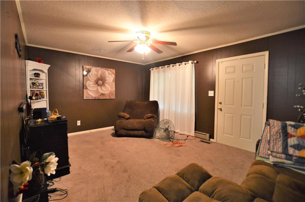 4096 Beach Road, Unit 7 Hudson, NC 28638 - Photo 4 of 13 a living room with furniture and a flat screen tv