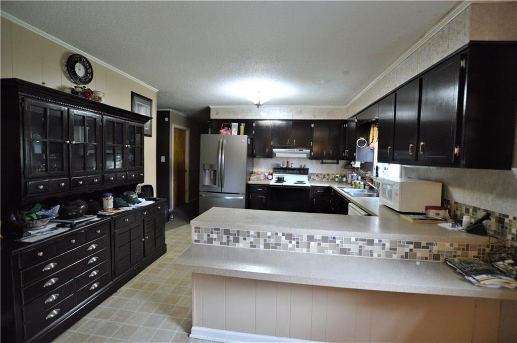 4096 Beach Road, Unit 7 Hudson, NC 28638 - Photo 6 of 13 a kitchen with a refrigerator and a stove top oven