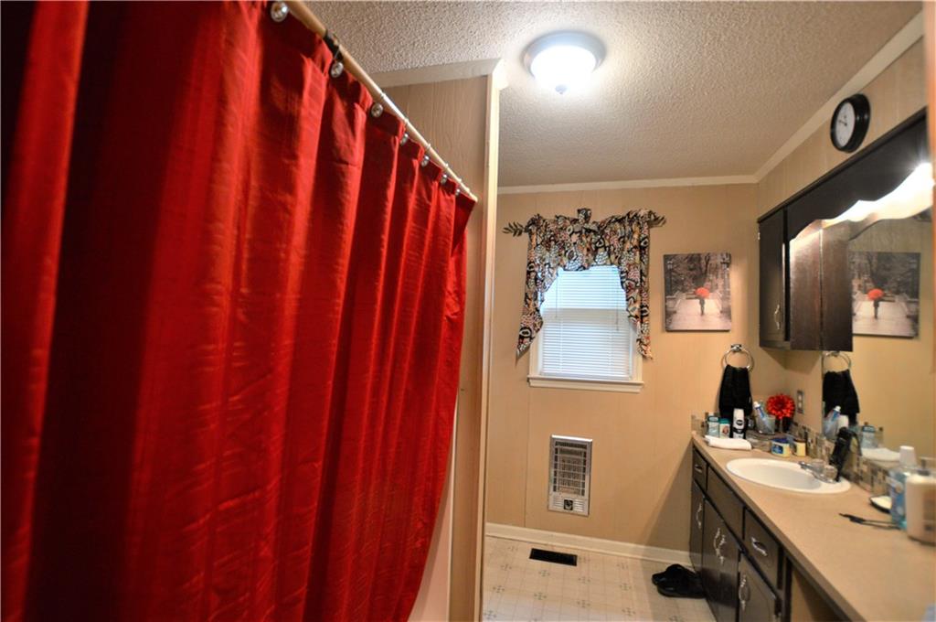 4096 Beach Road, Unit 7 Hudson, NC 28638 - Photo 10 of 13 a bathroom with a sink and mirror with shower